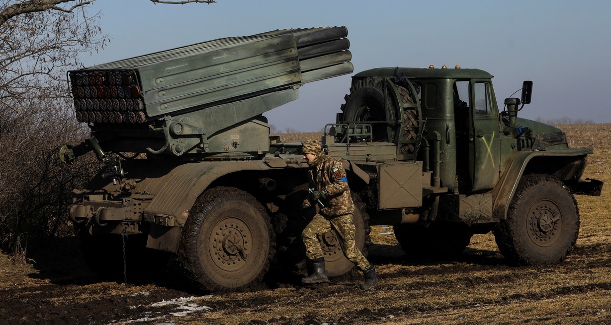 Un militar ucraniano corre junto a un sistema de cohetes de lanzamiento múltiple BM-21 Grad antes de disparar contra las tropas rusas. Créditos: Yevhenii Zavhorodnii/ Reuters