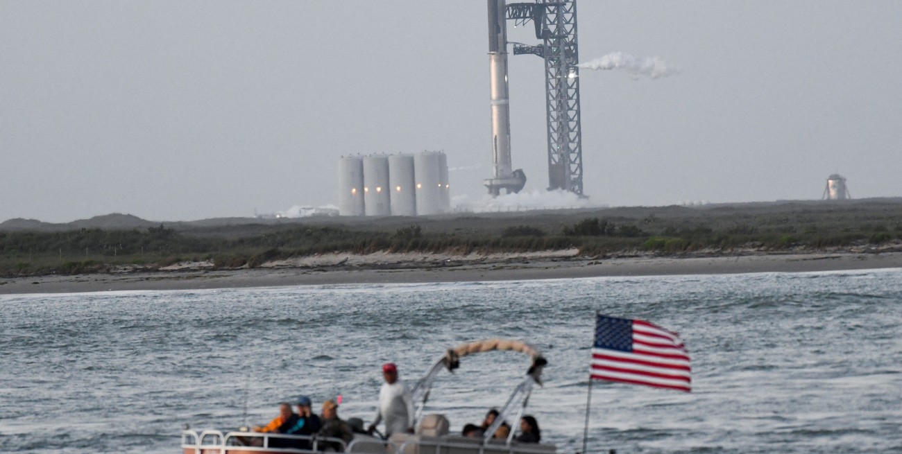 Un barco pasa cuando el lanzamiento de SpaceX Starship se detuvo en T-40 segundos debido a que una válvula se congeló, durante una misión de prueba orbital cerca de Brownsville, Texas. Crédito: Gene Blevins / Reuters