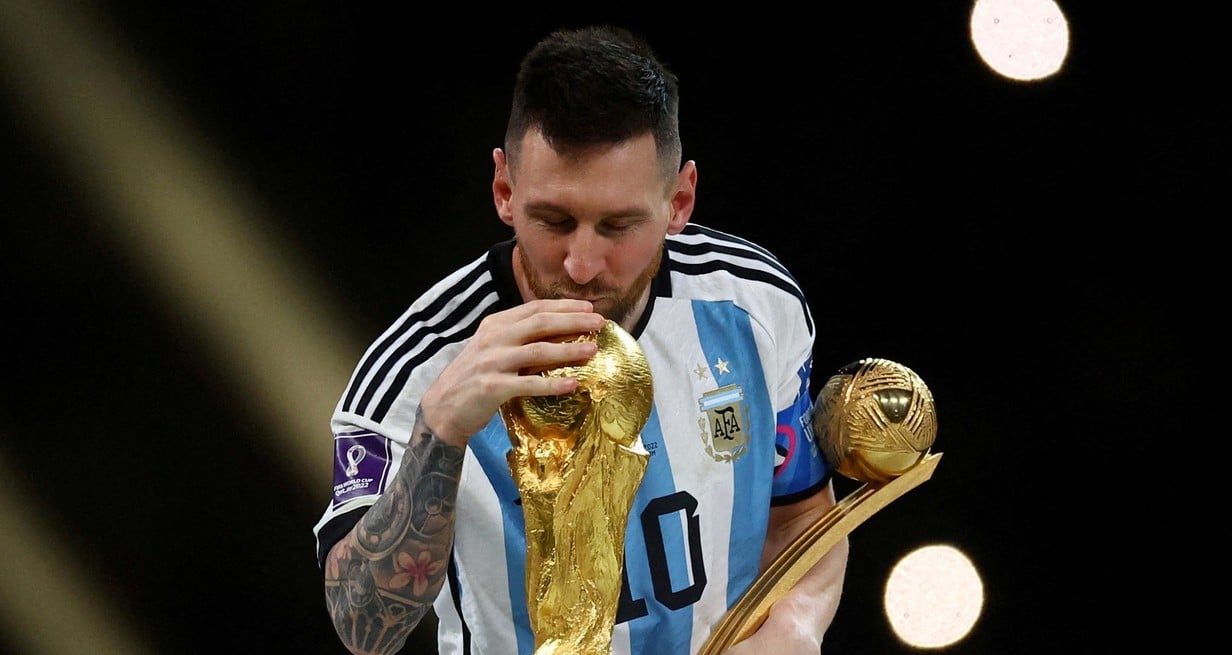 FILE PHOTO: Soccer Football - FIFA World Cup Qatar 2022 - Final - Argentina v France - Lusail Stadium, Lusail, Qatar - December 18, 2022
Argentina's Lionel Messi kisses the World Cup trophy after receiving the Golden Ball award as he celebrates after winning the World Cup REUTERS/Kai Pfaffenbach/File Photo