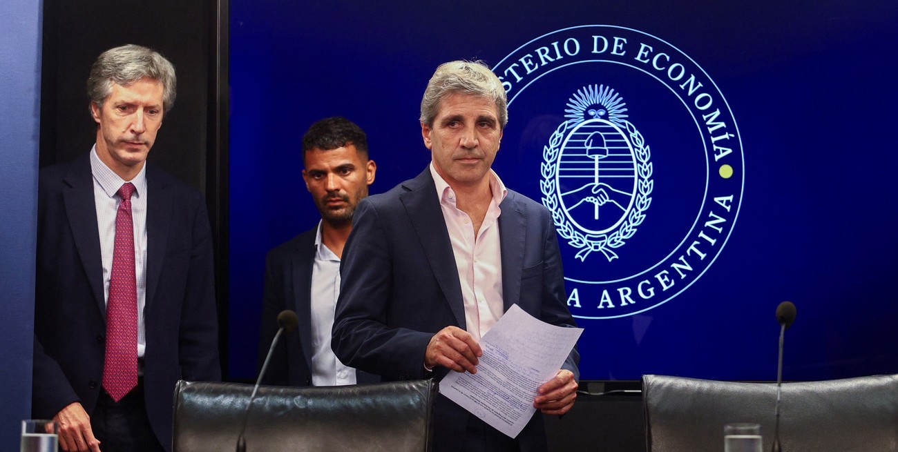 Argentina's Economy Minister Luis Caputo and Central Bank's President Santiago Bausili arrive for a press conference following a staff-level agreement with the International Monetary Fund (IMF) on the latest review of the country's $44 billion debt program, at the Economy Ministry building in Buenos Aires, Argentina, January 10, 2024. REUTERS/Matias Baglietto