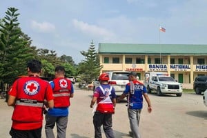 Emergency personnel walk at a site of a deadly shooting at a school in Banga, South Cotabato, Philippines, September 18, 2026. Philippine Red Cross/Handout via REUTERS THIS IMAGE HAS BEEN SUPPLIED BY A THIRD PARTY. NO RESALES. NO ARCHIVES. MANDATORY CREDIT. BEST QUALITY AVAILABLE.