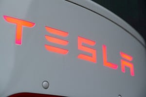 FILE PHOTO: The logo of Tesla is seen at a Tesla Supercharger station October 21, 2020. REUTERS/Arnd Wiegmann/File Photo