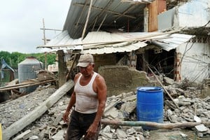 A man walks off his destroyed house following an earthquake in Isla Puna, Ecuador, March 19, 2023. REUTERS/Maria Fernanda Landin