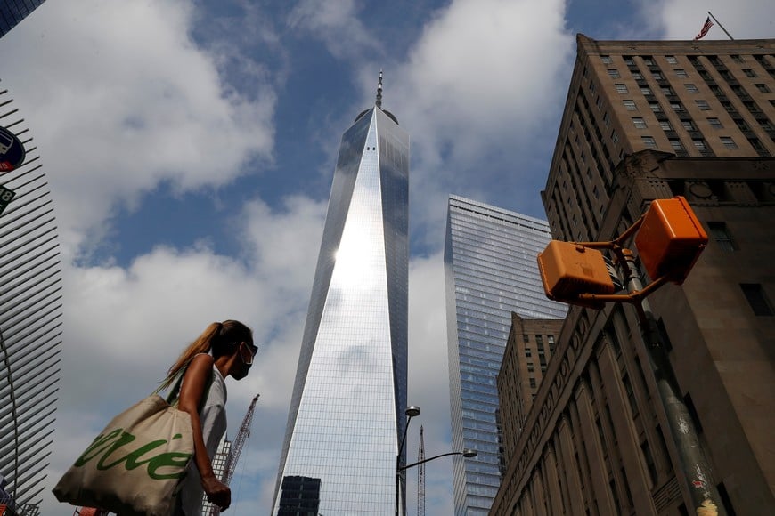 A woman wearing a protective face mask walks by One World Trade Center two days before the 19th anniversary of the 9/11 attacks, amid the coronavirus disease (COVID-19) pandemic, in the lower section Manhattan, New York City, U.S., September 9, 2020.   REUTERS/Shannon Stapleton