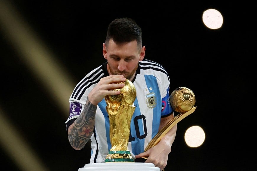 FILE PHOTO: Soccer Football - FIFA World Cup Qatar 2022 - Final - Argentina v France - Lusail Stadium, Lusail, Qatar - December 18, 2022
Argentina's Lionel Messi kisses the World Cup trophy after receiving the Golden Ball award as he celebrates after winning the World Cup REUTERS/Kai Pfaffenbach/File Photo
