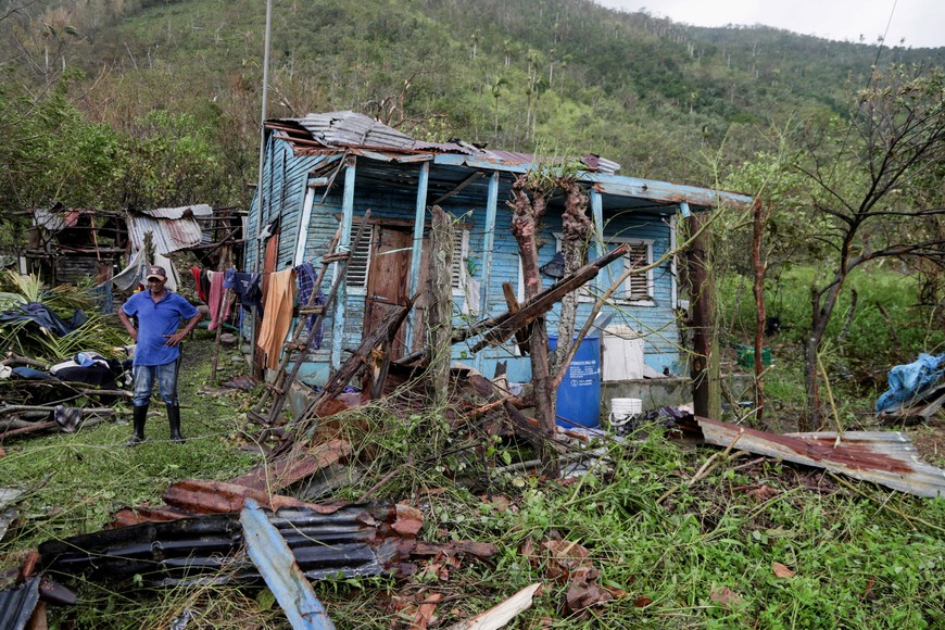 A man stands outside his destroyed house in the rural zone of Cuey in the aftermath of Hurricane Fiona, in El Seibo, Dominican Republic, September 20, 2022. REUTERS/Ricardo Rojas