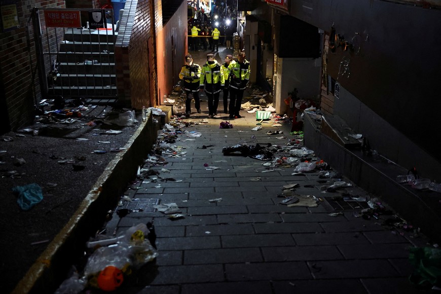 Police officers walk at the scene where many people died and were injured in a stampede during a Halloween festival in Seoul, South Korea, October 30, 2022. REUTERS/Kim Hong-ji     TPX IMAGES OF THE DAY