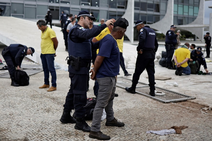 Supporters of Brazil's former President Jair Bolsonaro are detained during a demonstration against President Luiz Inacio Lula da Silva, outside Planalto Palace in Brasilia, Brazil, January 8, 2023. REUTERS/Ueslei Marcelino