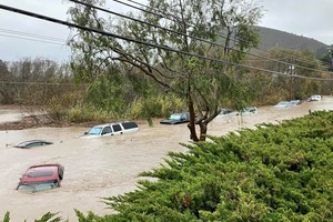 Cars are seen submerged in flood waters in Morro Bay, California, U.S., January 9, 2023 in this picture obtained from social media. Carolyn Krueger/via REUTERS  THIS IMAGE HAS BEEN SUPPLIED BY A THIRD PARTY. MANDATORY CREDIT. NO RESALES. NO ARCHIVES.