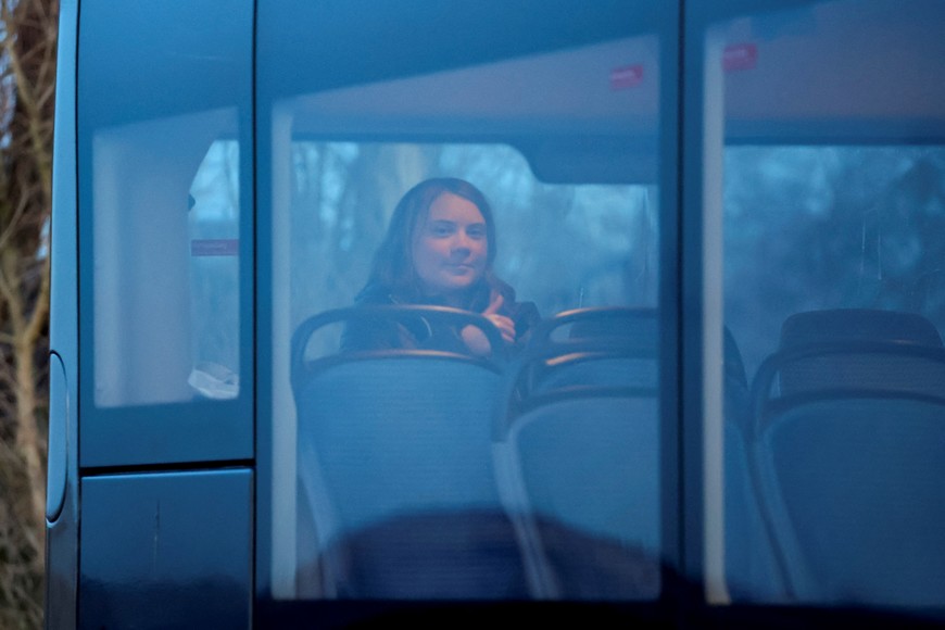 Climate activist Greta Thunberg gestures as she sits in a bus on the day of a protest against the expansion of the Garzweiler open-cast lignite mine of Germany's utility RWE to Luetzerath, in Germany, January 17, 2023 that has highlighted tensions over Germany's climate policy during an energy crisis. REUTERS/Wolfgang Rattay
