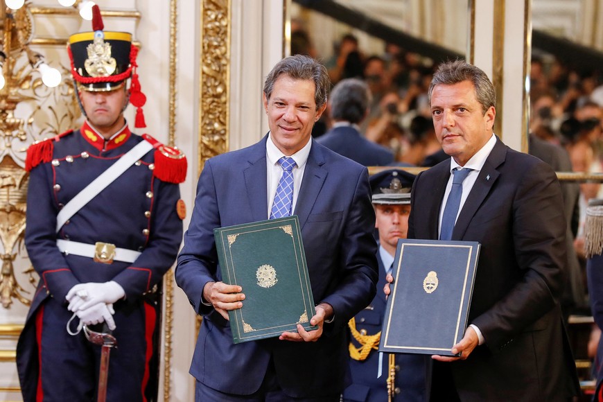 Argentina's Economic Minister Sergio Massa and Brazil's Finance Minister Fernando Haddad hold the bilateral agreements, during a signing ceremony, at the Casa Rosada presidential palace in Buenos Aires, Argentina, January 23, 2023. REUTERS/Agustin Marcarian