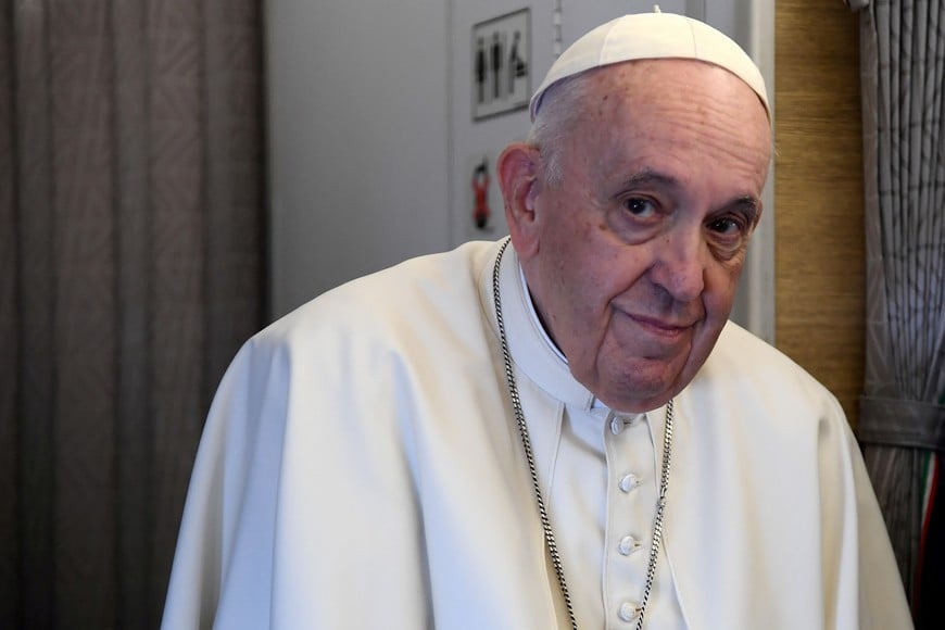 Pope Francis greets the media on board the papal plane en route to the Kazakh capital of Nur-Sultan at the start of his three-day visit to the Central Asian country, September 13, 2022. Filippo Monteforte/Pool via REUTERS