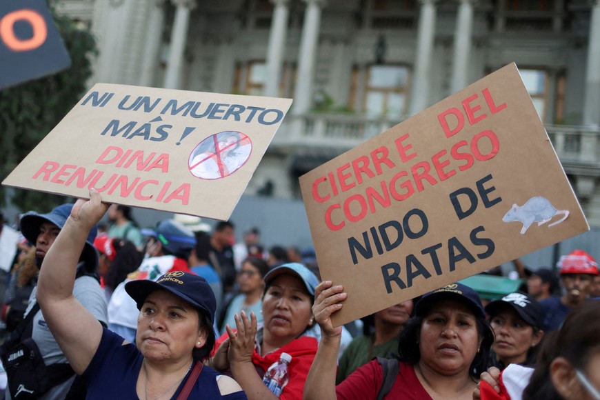 FILE PHOTO: Demonstrators hold signs reading "Not one more dead, Dina resign" and "Closure of the Congress, nest of rats" amid anti-government protests after Peru's former President Pedro Castillo was ousted, in Lima, Peru January 23, 2023. REUTERS/Pilar Olivares/File Photo