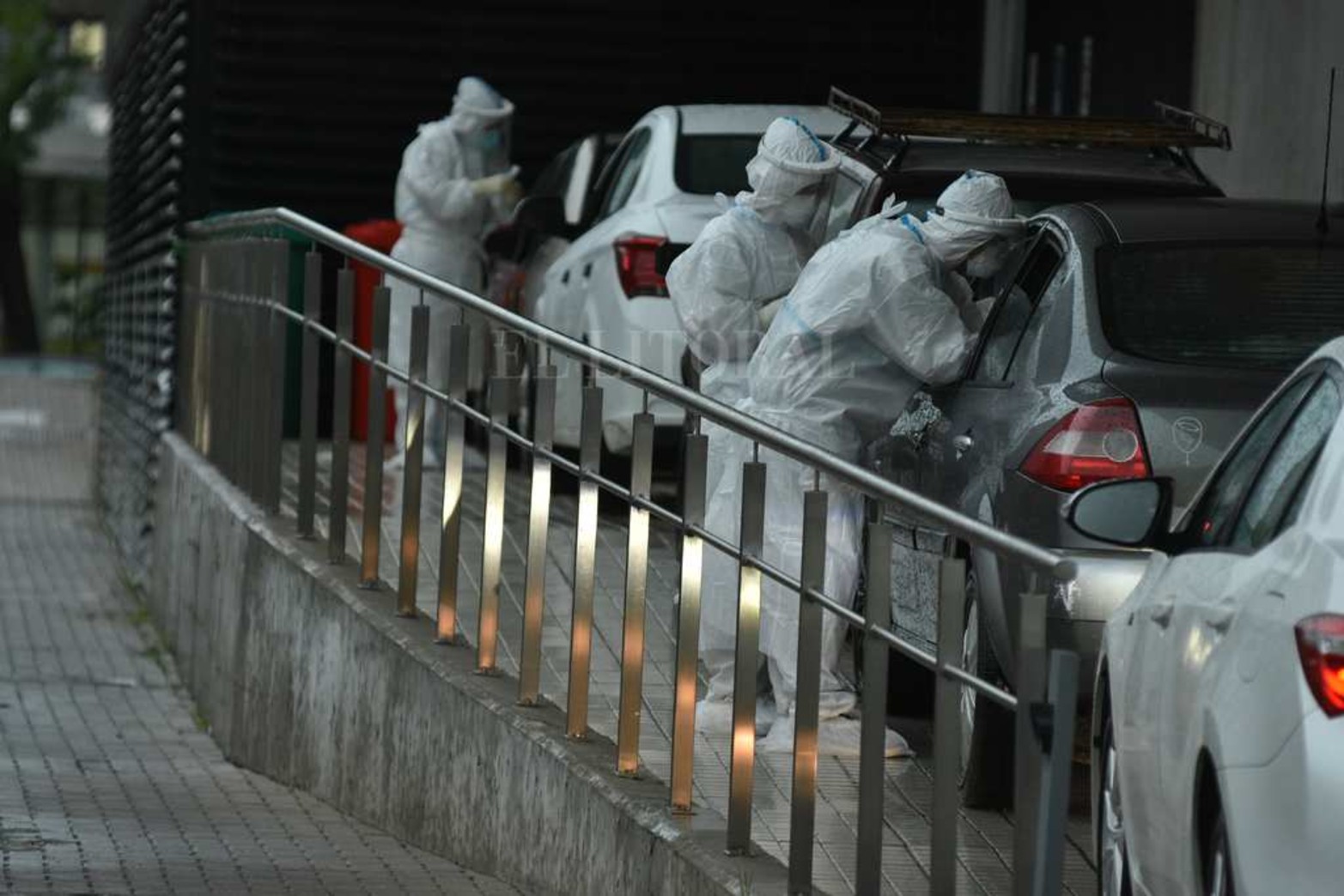 Bajo la lluvia. Empleados de salud haciendo hisopada en el CEMAFE.