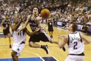 RONALD MARTINEZ Manu Ginobili of the San Antonio Spurs drives for a shot attempt against Adrian Griffin and Keith Van Horn (R) of the Dallas Mavericks in Game Six of the Western Conference Semifinals during the 2006 NBA Playoffs 19 May 2006 at American Airlines Center in Dallas, Texas.  Ronald Martinez/Getty Images/AFP = FOR NEWSPAPERS AND TV USE ONLY =