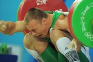 Agencia EFE Janos Baranyai of Hungary grimaces after failing a lift in the men's 77 kg group B weightlifting event during the 2008 Beijing Olympic Games on August 13, 2008. AFP PHOTO/JUNG YEON-JE