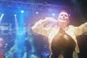 IAA Sharon den Adel escucha cómo el público corea las partes de Tarja Turunen (en la pantalla de fondo) en Paradise (What about us?) .