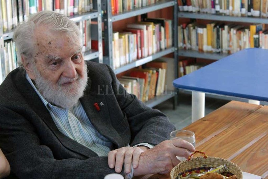 ELLITORAL_255257 |  Archivo El Litoral Bayer en la Bayer. Osvaldo Bayer visitó la biblioteca cuando vino a Santa Fe acompañando su obra teatral  Las putas de San Julián , en 2014. En una inolvidable charla con los hacedores de la biblioteca, el escritor y periodista compartió anécdotas de su vida, durante más de dos horas, y se interiorizó de las actividades barriales. Al despedirse, les regaló uno de sus últimos libros,  La historia de la crueldad argentina , con una hermosa dedicatoria. Y les dejó su imagen y ejemplo de luchador incansable.