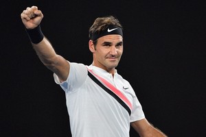 SAEED KHAN Switzerland's Roger Federer celebrates beating Germany's Jan-Lennard Struff in their men's singles second round match on day four of the Australian Open tennis tournament in Melbourne on January 18, 2018. / AFP PHOTO / SAEED KHAN / -- IMAGE RESTRICTED TO EDITORIAL USE - STRICTLY NO COMMERCIAL USE -- (Photo credit should read SAEED KHAN/AFP/Getty Images)