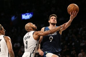 ELLITORAL_414024 |  Reuters Oct 14, 2021; Brooklyn, New York, USA; Minnesota Timberwolves guard Leandro Bolmaro (9) drives to the basket against Brooklyn Nets guard Jevon Carter (0) during the second quarter at Barclays Center. Mandatory Credit: Brad Penner-USA TODAY Sports