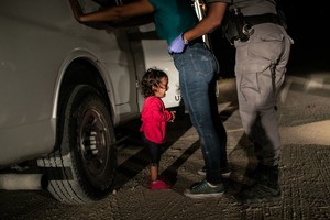 ELLITORAL_243897 |  John Moore A two-year-old Honduran asylum seeker cries as her mother is searched and detained near the U.S.-Mexico border on June 12, 2018 in McAllen, Texas. They had rafted across the Rio Grande from Mexico and were detained by U.S. Border Patrol agents before being sent to a processing center. The following week the Trump administration, under pressure from the public and lawmakers, ended its contraversial policy of separating immigrant children from their parents at the U.S.-Mexico border. Although the child and her mother remained together, they were sent to a series of detention facilities before being released weeks later, pending a future asylum hearing.