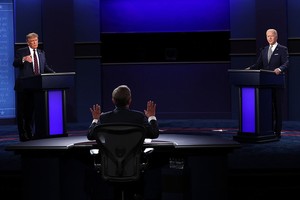 Scott Olson/Getty Images/AFP CLEVELAND, OHIO - SEPTEMBER 29: U.S. President Donald Trump and Democratic presidential nominee Joe Biden participate in the first presidential debate moderated by Fox News anchor Chris Wallace (C) at the Health Education Campus of Case Western Reserve University on September 29, 2020 in Cleveland, Ohio. This is the first of three planned debates between the two candidates in the lead up to the election on November 3.   Scott Olson/Getty Images/AFP