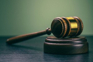 Marilyn Nieves Gavel on desk. Isolated with good copy space. Dramatic lighting.