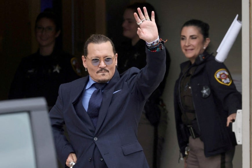 FILE PHOTO: Actor Johnny Depp gestures as he leaves the Fairfax County Circuit Courthouse following his defamation trial against his ex-wife Amber Heard, in Fairfax, Virginia, U.S., May 27, 2022. REUTERS/Evelyn Hockstein/File Photo