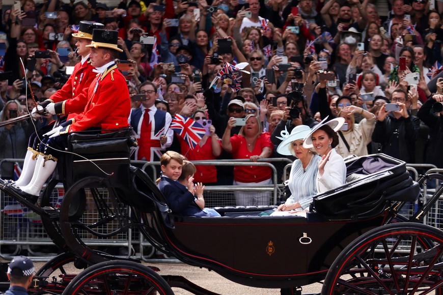 Britain's Catherine, Duchess of Cambridge and Camilla, Duchess of Cornwall along with Prince George, Prince Louis and Princess Charlotte, ride in a carriage during the Trooping the Colour parade in celebration of Britain's Queen Elizabeth's Platinum Jubilee, in London, Britain, June 2, 2022. REUTERS/Tom Nicholson