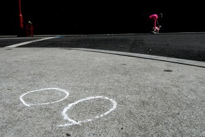 Police markings are pictured on the street as locals walk by the scenes after a deadly mass shooting on South Street in Philadelphia, Pennsylvania, U.S., June 5, 2022. REUTERS/Bastiaan Slabbers