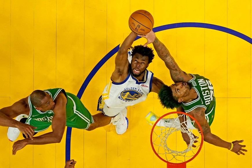 Jun 5, 2022; San Francisco, California, USA; Golden State Warriors forward Andrew Wiggins (22) goes for a rebound against Boston Celtics guard Marcus Smart (36) and center Al Horford (42) during game two of the 2022 NBA Finals at Chase Center. Mandatory Credit: Ezra Shaw/pool photo-USA TODAY Sports