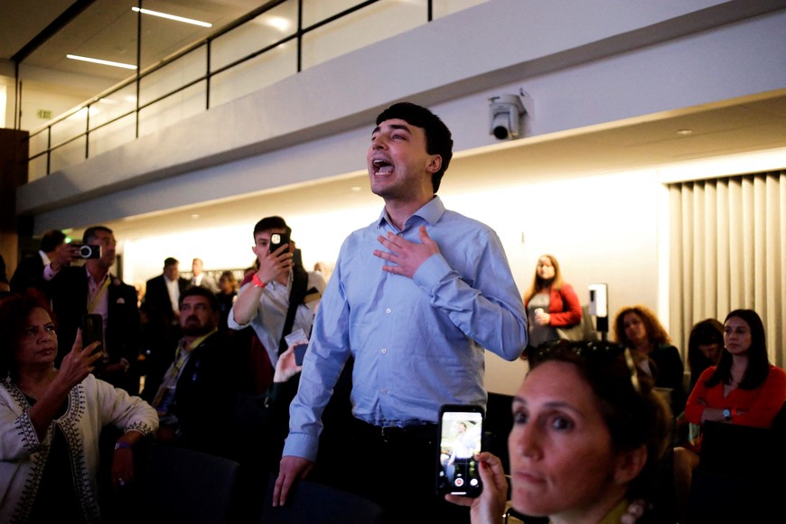 A person protests while Secretary-General of the Organization of American States Luis Almagro attends a discussion panel on the commitment to journalistic freedom at the Summit of the Americas in Los Angeles, California, U.S., June 7, 2022. REUTERS/Daniel Becerril REFILE-CLARIFYING CAPTION