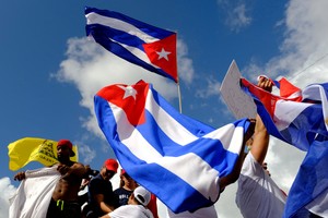 FILE PHOTO: Emigres waving Cuban flags in Little Havana react to reports of protests in Cuba against the deteriorating economy, in Miami, Florida, U.S., July 11, 2021.   REUTERS/Maria Alejandra Cardona/File Photo
