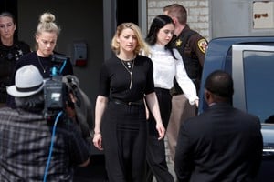 Amber Heard leaves Fairfax County Circuit Courthouse after the jury announced split verdicts in favor of both her ex-husband Johnny Depp and Heard on their claim and counter-claim in the Depp v. Heard civil defamation trial at the Fairfax County Circuit Courthouse in Fairfax, Virginia, U.S., June 1, 2022. REUTERS/Tom Brenner