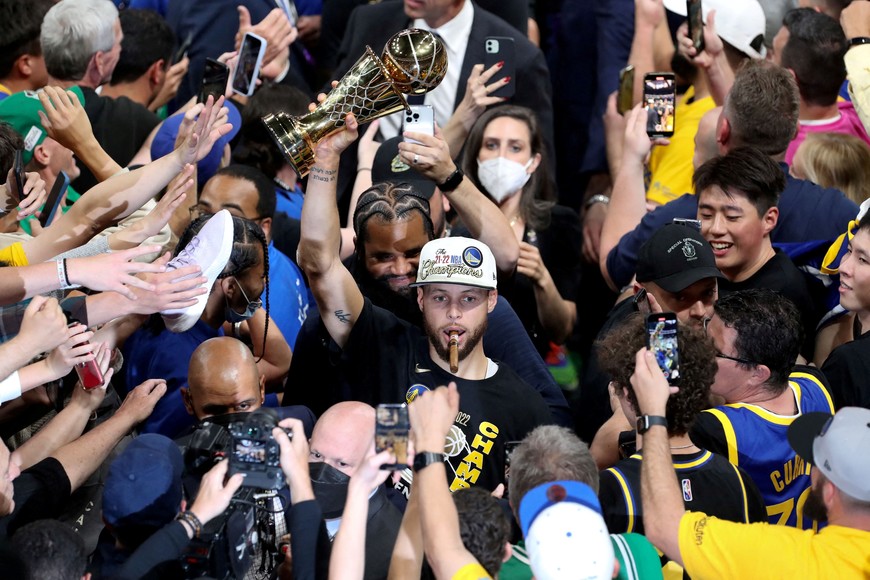 Jun 16, 2022; Boston, Massachusetts, USA; Golden State Warriors guard Stephen Curry (30) holds up the Most Valuable Player Trophy after defeating the Boston Celtics in game six in the 2022 NBA Finals at the TD Garden. Mandatory Credit: Paul Rutherford-USA TODAY Sports     TPX IMAGES OF THE DAY