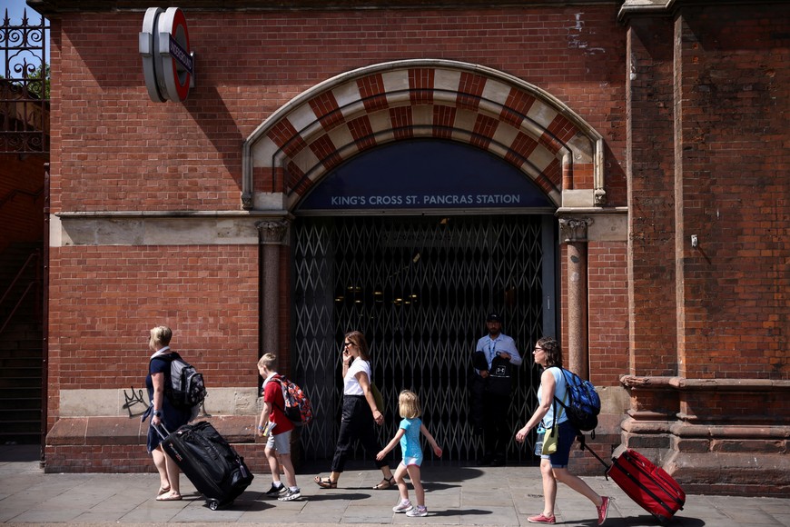 People walk past a closed entrance to the underground train station on the first day of national rail strike in London, Britain, June 21, 2022. REUTERS/Henry Nicholls??