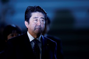 FILE PHOTO: Japan's Prime Minister Shinzo Abe arrives at his official residence in Tokyo January 23, 2015. It is an unlikely friendship that ties the fates of war correspondent Kenji Goto and troubled loner Haruna Yukawa, the two Japanese hostages for whom Islamic State militants demanded a $200 million ransom this week. REUTERS/Yuya Shino/File Photo