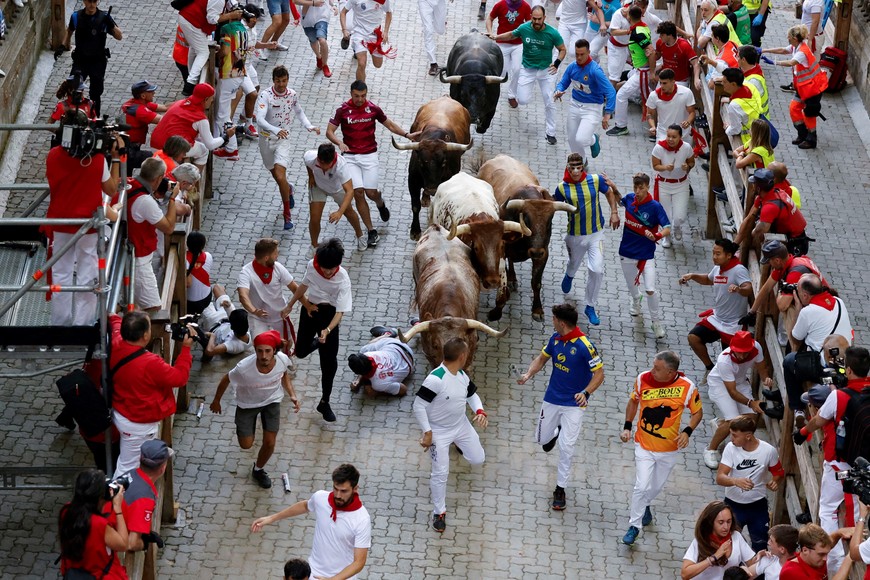 Revellers sprint during the running of the bulls at the San Fermin festival in Pamplona, Spain, July 14, 2022. REUTERS/Juan Medina
