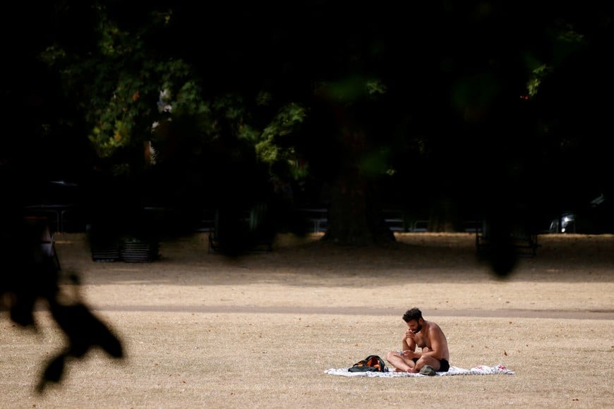 A man sunbathes in St James's Park during the hot weather in London, Britain, July 18, 2022. REUTERS/John Sibley