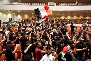 Supporters of Iraqi Shi'ite cleric Moqtada al-Sadr protest against corruption, inside the parliament in Baghdad, Iraq July 30, 2022. REUTERS/Thaier Al-Sudani