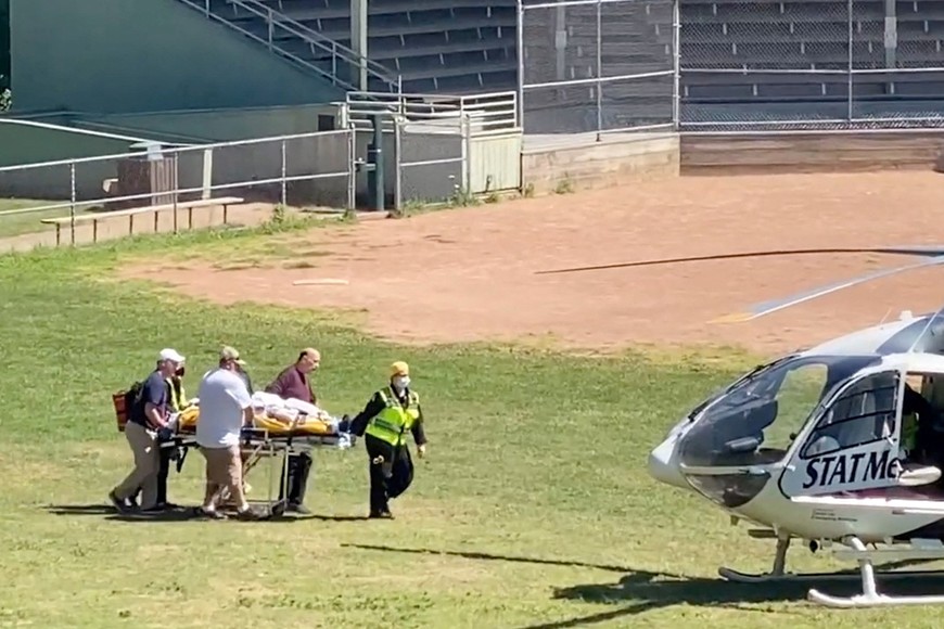 Author Salman Rushdie is transported to a helicopter after he was stabbed on stage before his scheduled speech at the Chautauqua Institution, Chautauqua, New York, U.S., August 12, 2022, in this screengrab taken from a social media video. TWITTER @HoratioGates3 /via REUTERS  THIS IMAGE HAS BEEN SUPPLIED BY A THIRD PARTY. MANDATORY CREDIT.