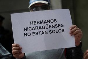 A sign that reads "Nicaraguan brothers: you are not alone" is pictured as members of organisations take part in a protest to demand respect for religious freedom and an end to the persecution against the church and against the opponents of the government of Nicaraguan President Daniel Ortega, outside the Nicaraguan Embassy in Mexico City, Mexico, August 16, 2022. REUTERS/Edgard Garrido