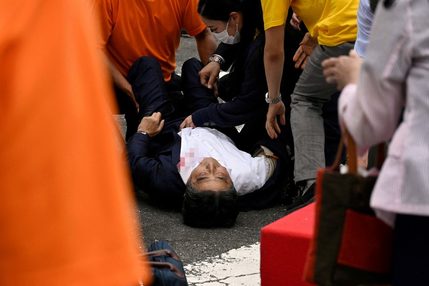 Former Japanese Prime Minister Shinzo Abe lies on the ground after he was shot during an election campaign in Nara, western Japan July 8, 2022 in this photo taken by The Asahi Shimbun. Image pixelated at source. The Asahi Shimbun/via REUTERS ATTENTION EDITORS - THIS IMAGE WAS PROVIDED BY A THIRD PARTY. MANDATORY CREDIT. NO RESALES. NO ARCHIVES. JAPAN OUT. NO COMMERCIAL OR EDITORIAL SALES IN JAPAN. 
     TPX IMAGES OF THE DAY