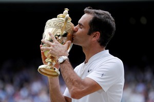FILE PHOTO: Tennis - Wimbledon - London, Britain - July 16, 2017   Switzerland’s Roger Federer celebrates with the trophy after winning the final against Croatia’s Marin Cilic     REUTERS/Andrew Couldridge/File Photo