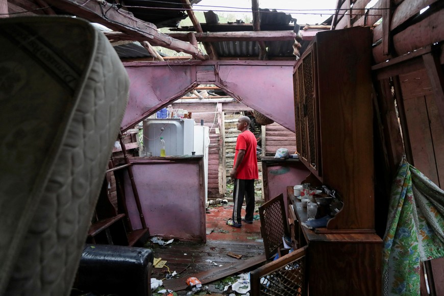A man stands inside his destroyed house in the rural zone of Cuey, in the aftermath of Hurricane Fiona, in El Seibo, Dominican Republic, September 20, 2022. REUTERS/Ricardo Rojas