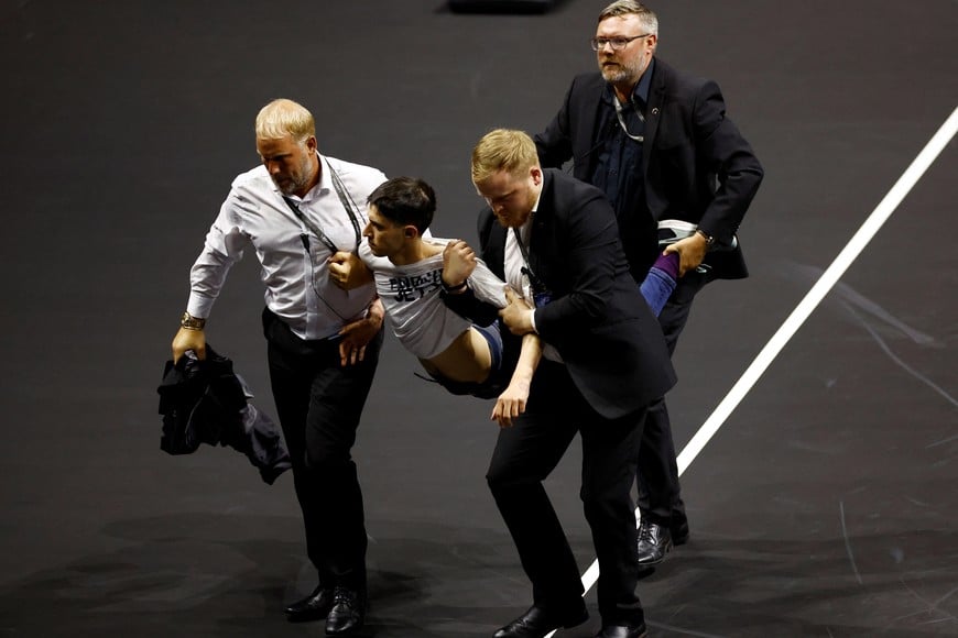 Tennis - Laver Cup - 02 Arena, London, Britain - September 23, 2022  
A protester is removed from the court during the match between Team Europe's Stefanos Tsitsipas and Team World's Diego Schwartzman Action Images via Reuters/Andrew Boyers