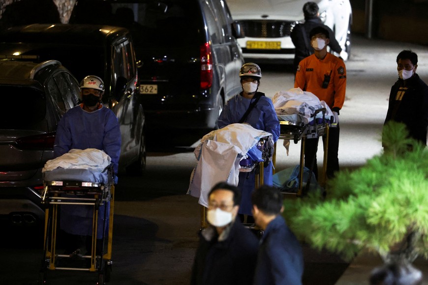 People move bodies to be transported from hospital, after a stampede during a Halloween festival in Seoul, South Korea, October 30, 2022. REUTERS/Kim Hong-ji     TPX IMAGES OF THE DAY