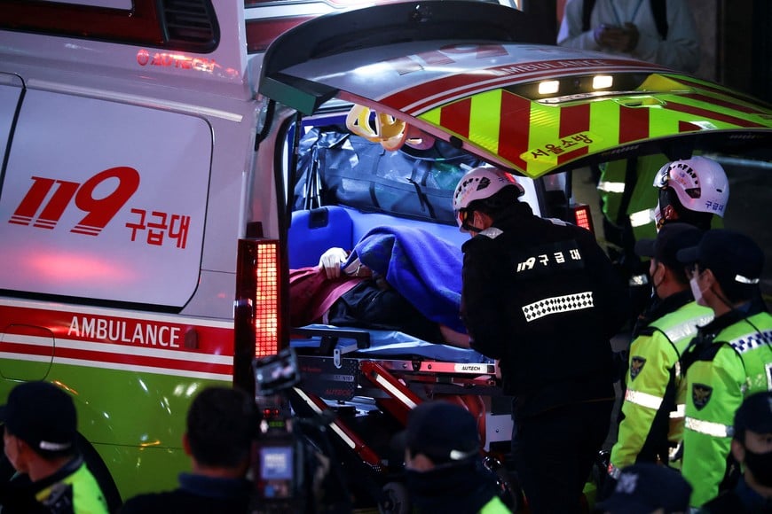A person receives medical help at the scene where dozens of people were injured in a stampede during a Halloween festival in Seoul, South Korea, October 30, 2022. REUTERS/Kim Hong-ji REFILE - CORRECTING DATE