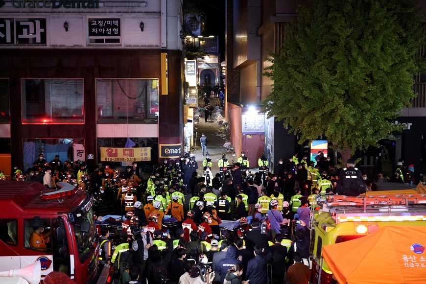 Rescue team and firefighters work at the scene where dozens of people were injured in a stampede during a Halloween festival in Seoul, South Korea, October 30, 2022. REUTERS/Kim Hong-ji REFILE - CORRECTING DATE