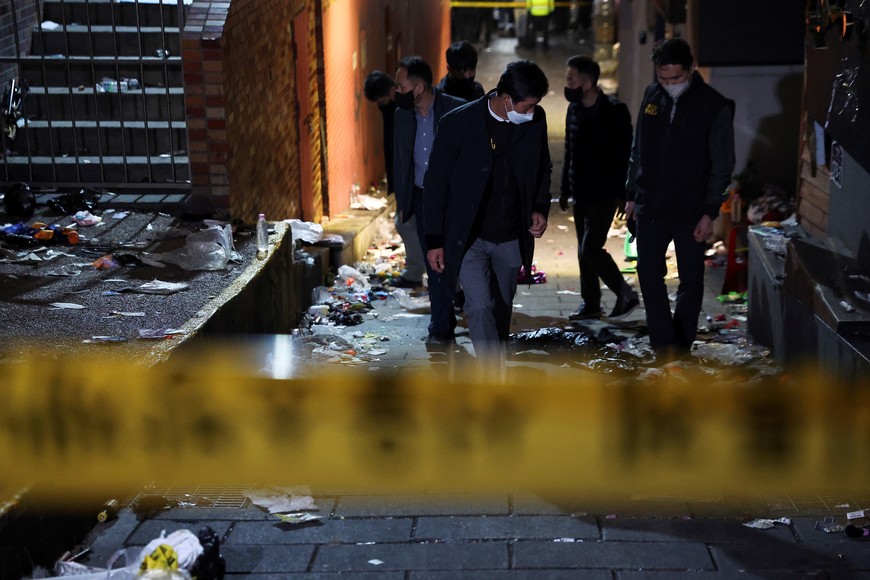 Investigators inspect the scene where many people died and were injured in a stampede during a Halloween festival in Seoul, South Korea, October 30, 2022. REUTERS/Kim Hong-ji